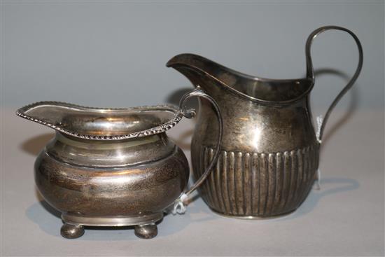 Two silver cream jugs.